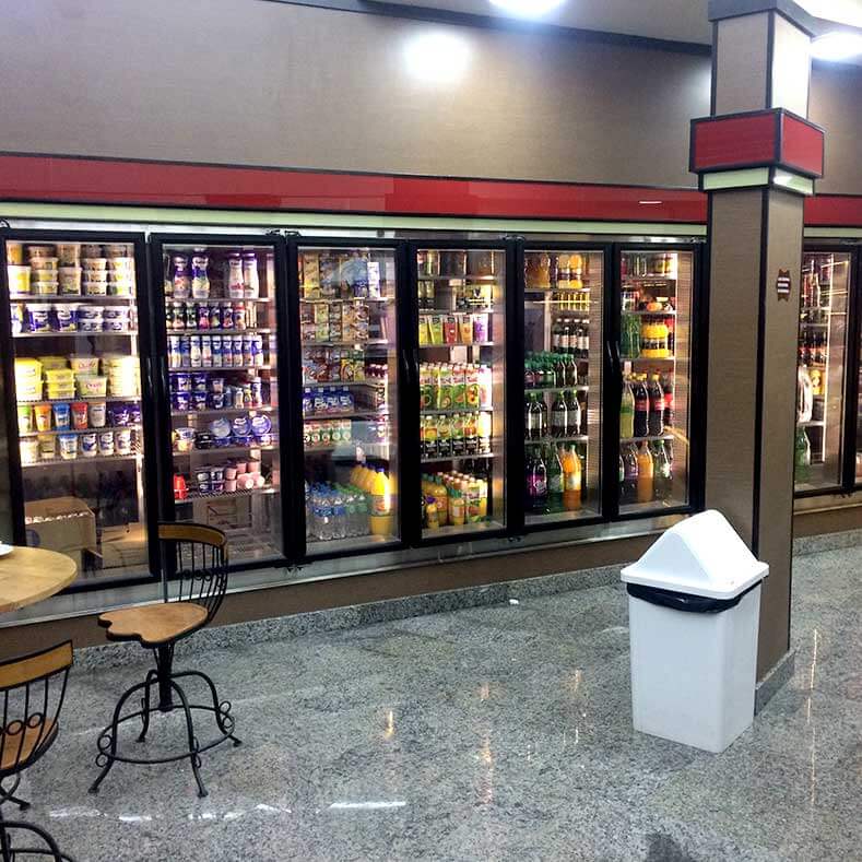 FreeArt - Câmara fria expositora 10m<sup>2</sup> de área de estoque com 8 portas expositoras, prateleiras moduladas com regulagem de altura.